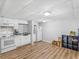 Kitchen with white cabinets, appliances, and laminate flooring at 3500 Stonewall Pl, Atlanta, GA 30339
