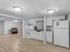 Kitchen with white cabinets, appliances, and laminate flooring at 3500 Stonewall Pl, Atlanta, GA 30339