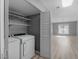 Convenient laundry area featuring a washer, dryer, and shelving for storage at 3500 Stonewall Pl, Atlanta, GA 30339