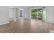 Open living room with hardwood floors, sliding door to balcony, and large windows at 3500 Stonewall Pl, Atlanta, GA 30339