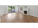 Open living room with hardwood floors, sliding door to balcony, and fireplace at 3500 Stonewall Pl, Atlanta, GA 30339
