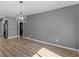 Spacious living room with wood-look flooring and modern light fixture at 3500 Stonewall Pl, Atlanta, GA 30339