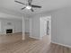 Open living room featuring hardwood floors, fireplace, ceiling fan and natural light at 3500 Stonewall Pl, Atlanta, GA 30339
