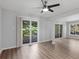 Open living room with hardwood floors, sliding door to balcony, and large windows at 3500 Stonewall Pl, Atlanta, GA 30339