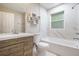 Bright bathroom with a modern vanity, tub, and shower combination at 446 Waterford Nw Rd, Atlanta, GA 30318