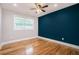 Bedroom boasts hardwood floors, ceiling fan, and ample natural light through two windows at 446 Waterford Nw Rd, Atlanta, GA 30318