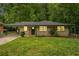 Charming home front featuring a brick exterior, covered parking, and manicured lawn at 446 Waterford Nw Rd, Atlanta, GA 30318