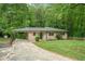 Cozy home with covered carport and a charming front yard, nestled in a serene, tree-filled setting at 446 Waterford Nw Rd, Atlanta, GA 30318