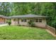 Charming bungalow with a lush green front yard and mature trees in a desirable neighborhood at 446 Waterford Nw Rd, Atlanta, GA 30318
