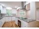 Bright and modern kitchen with white cabinetry, granite countertops, and stainless steel appliances at 446 Waterford Nw Rd, Atlanta, GA 30318