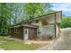 Rear exterior featuring a covered patio, a door, and a brick walkway at 446 Waterford Nw Rd, Atlanta, GA 30318
