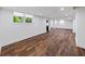 Large finished basement with laminate floors, bright lighting, and a window offering natural light at 579 Fielding Ln, Atlanta, GA 30311