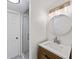 Bright bathroom with white countertops, a wood vanity, modern lighting and glass shower at 579 Fielding Ln, Atlanta, GA 30311