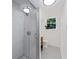 Bathroom featuring a glass shower with modern tiles, grey floors, and a window at 579 Fielding Ln, Atlanta, GA 30311