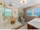 Modern bathroom featuring a glass enclosed shower with dual shower heads, a tile surround, and a wood vanity at 579 Fielding Ln, Atlanta, GA 30311