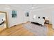 Spacious bedroom featuring hardwood floors, a ceiling fan, neutral decor, and natural light from the large windows at 579 Fielding Ln, Atlanta, GA 30311