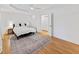 Bright bedroom features hardwood floors, white trim, neutral decor, a ceiling fan, and natural light from the windows at 579 Fielding Ln, Atlanta, GA 30311