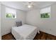 This cozy bedroom features two sunny windows, hardwood floors, and a ceiling fan at 579 Fielding Ln, Atlanta, GA 30311