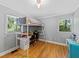 Bright bedroom featuring a lofted bed with built-in desk, hardwood floors, and ample natural light at 579 Fielding Ln, Atlanta, GA 30311