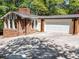 Brick home featuring an attached garage and long driveway at 579 Fielding Ln, Atlanta, GA 30311