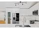 Bright kitchen boasts white cabinetry, stainless steel appliances, subway tile backsplash, and a modern faucet and lighting at 579 Fielding Ln, Atlanta, GA 30311
