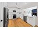 Modern kitchen with stainless steel appliances, white cabinets, and hardwood floors creating a bright and functional space at 579 Fielding Ln, Atlanta, GA 30311