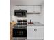 Basement kitchenette featuring modern stainless steel appliances, white cabinetry, and marble countertop at 579 Fielding Ln, Atlanta, GA 30311