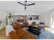 Bright open concept living room featuring hardwood floors, access to the dining room, and access to the kitchen at 579 Fielding Ln, Atlanta, GA 30311