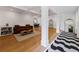 Bright living room features a cozy brown couch, stylish decor, hardwood floors, and elegant pillars at 579 Fielding Ln, Atlanta, GA 30311