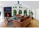 Bright living room featuring a fireplace, large windows with sheer curtains, hardwood floors, and modern furniture at 579 Fielding Ln, Atlanta, GA 30311