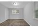 Neutral carpet, light walls, and natural light from windows create a comfortable bedroom space at 1008 Hope Springs Ct, Stone Mountain, GA 30083