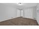Bedroom featuring neutral carpet, light walls, double windows, closet space, and a serene atmosphere at 1008 Hope Springs Ct, Stone Mountain, GA 30083