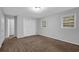 Bedroom showcasing neutral carpet, light walls, natural light from windows, and closet space at 1008 Hope Springs Ct, Stone Mountain, GA 30083