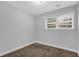 Bedroom showcasing a window offering natural light and neutral carpeting at 1008 Hope Springs Ct, Stone Mountain, GA 30083