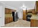 Functional kitchen features wood cabinetry, black appliances, and neutral countertops at 1008 Hope Springs Ct, Stone Mountain, GA 30083
