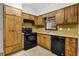 Cozy kitchen featuring wooden cabinets, laminate countertops, and black appliances at 1008 Hope Springs Ct, Stone Mountain, GA 30083