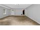 Spacious living room with neutral paint, and a view to the front yard through the window at 1008 Hope Springs Ct, Stone Mountain, GA 30083
