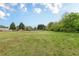 Expansive green backyard, partially fenced, with scattered trees, showcasing a generous outdoor space at 1316 Durham Ter, Mcdonough, GA 30252