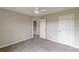 This cozy bedroom has neutral walls, carpeting, and two access doors at 1316 Durham Ter, Mcdonough, GA 30252
