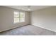 Bedroom with neutral walls, a ceiling fan, a large window, and soft carpeting at 1316 Durham Ter, Mcdonough, GA 30252