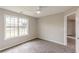 Comfortable bedroom with soft carpeting, a large window, and access to the hallway at 1316 Durham Ter, Mcdonough, GA 30252