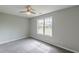 Bright bedroom with a window, neutral colors, and carpet at 1316 Durham Ter, Mcdonough, GA 30252