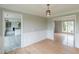 Neutral dining room with hardwood floors and updated lighting; access to the kitchen and another room at 1316 Durham Ter, Mcdonough, GA 30252