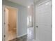 Inviting entryway featuring tiled floors, a view of the front door, and a convenient powder room for guests at 1316 Durham Ter, Mcdonough, GA 30252