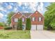 Charming brick two-story home featuring attached two-car garage and a well-maintained lawn at 1316 Durham Ter, Mcdonough, GA 30252