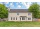 View of the back exterior of a two story house with large backyard at 1316 Durham Ter, Mcdonough, GA 30252