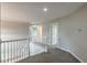 Upstairs hallway featuring neutral walls and carpeting, creating a seamless transition between rooms at 1316 Durham Ter, Mcdonough, GA 30252