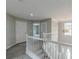 Carpeted hallway with staircase and natural light fixture at 1316 Durham Ter, Mcdonough, GA 30252