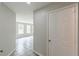 Hallway with gray walls and modern tiling leading to the spacious, naturally lit living room at 1316 Durham Ter, Mcdonough, GA 30252