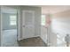 Hallway with stairs, a closet, and a hanging light fixture at 1316 Durham Ter, Mcdonough, GA 30252